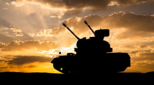 Military tank at sunset